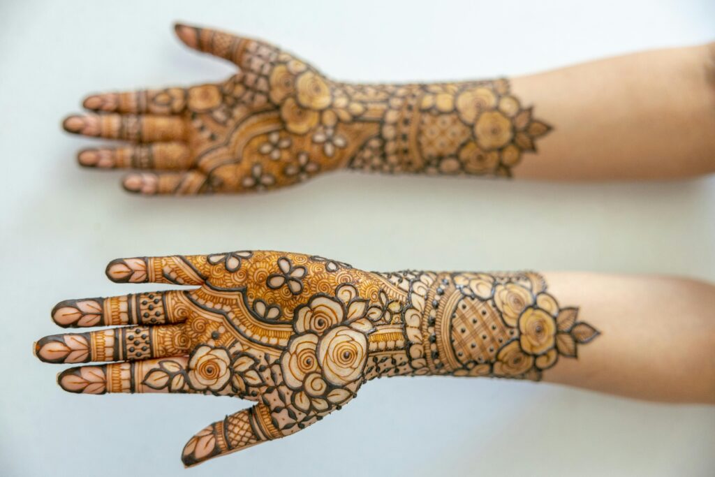 Intricate henna designs on forearms and hands, showcasing traditional artistry.